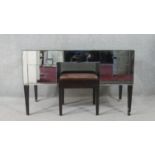 A mid 20th century mirrored kneehole dressing table, with an arrangement of five short drawers, on