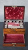 A 19th century rosewood and brass bound vanity travel box with silver lidded boxes and bottles,