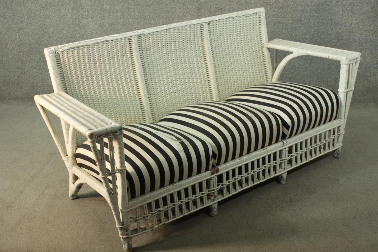 A white painted rattan garden three seater sofa, of woven construction, with a black and white - Image 3 of 9