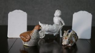 A collection of porcelain, including a hand painted partridge box, a white porcelain cherub
