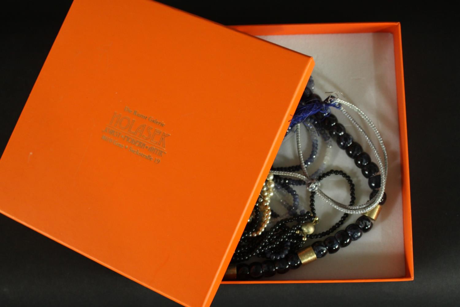 A boxed group of necklaces, including: a sapphire and white sapphire facetted bead necklace, an - Image 2 of 11