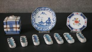 A collection of Oriental ceramics, including a cross hatched design ink bottle, a set of seven