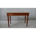 A Victorian mahogany two drawer side table, of rectangular form, on turned legs. H.75 W.107 D.53cm