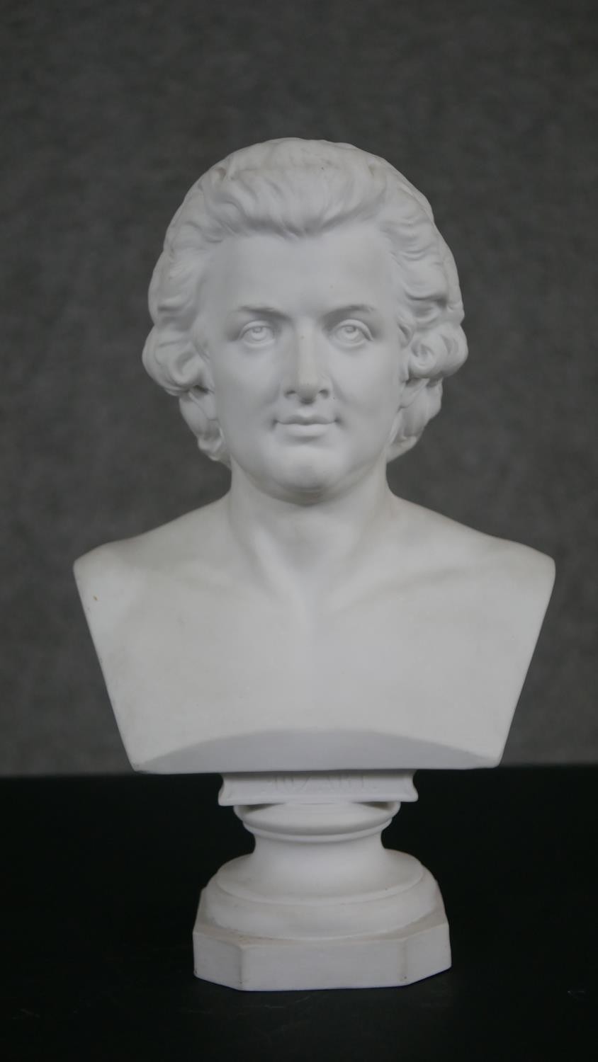 A Parian ware bust of Mozart, the bust inscribed below and on plinth base. H.30 W.18 D.10cm