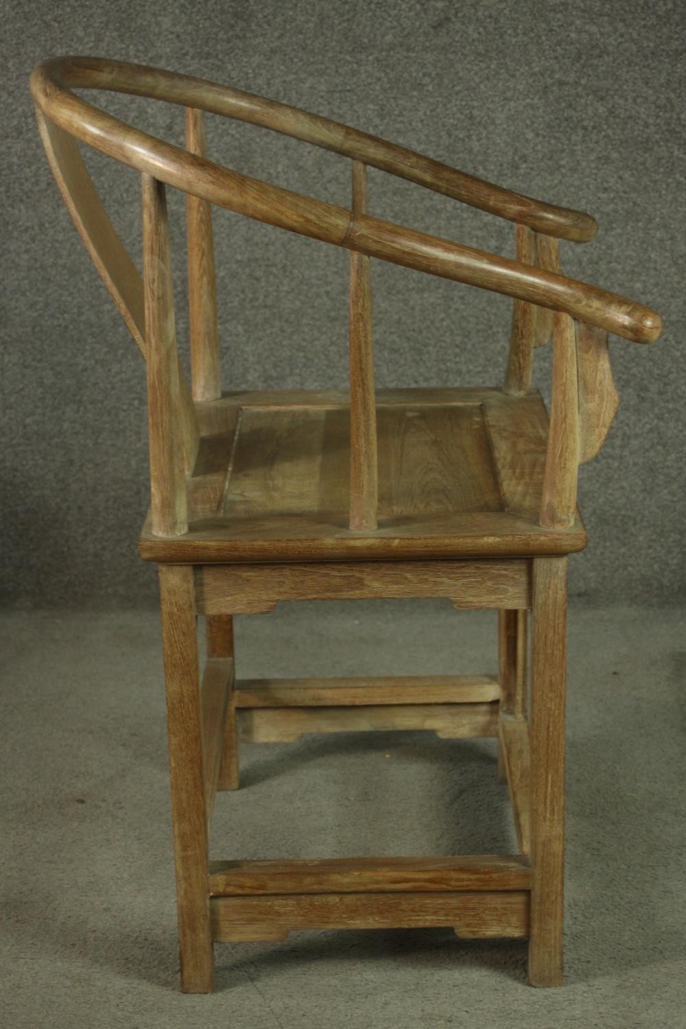 A pair of Chinese teak horseshoe back armchairs, with a plain splat back, the legs joined by - Image 5 of 17