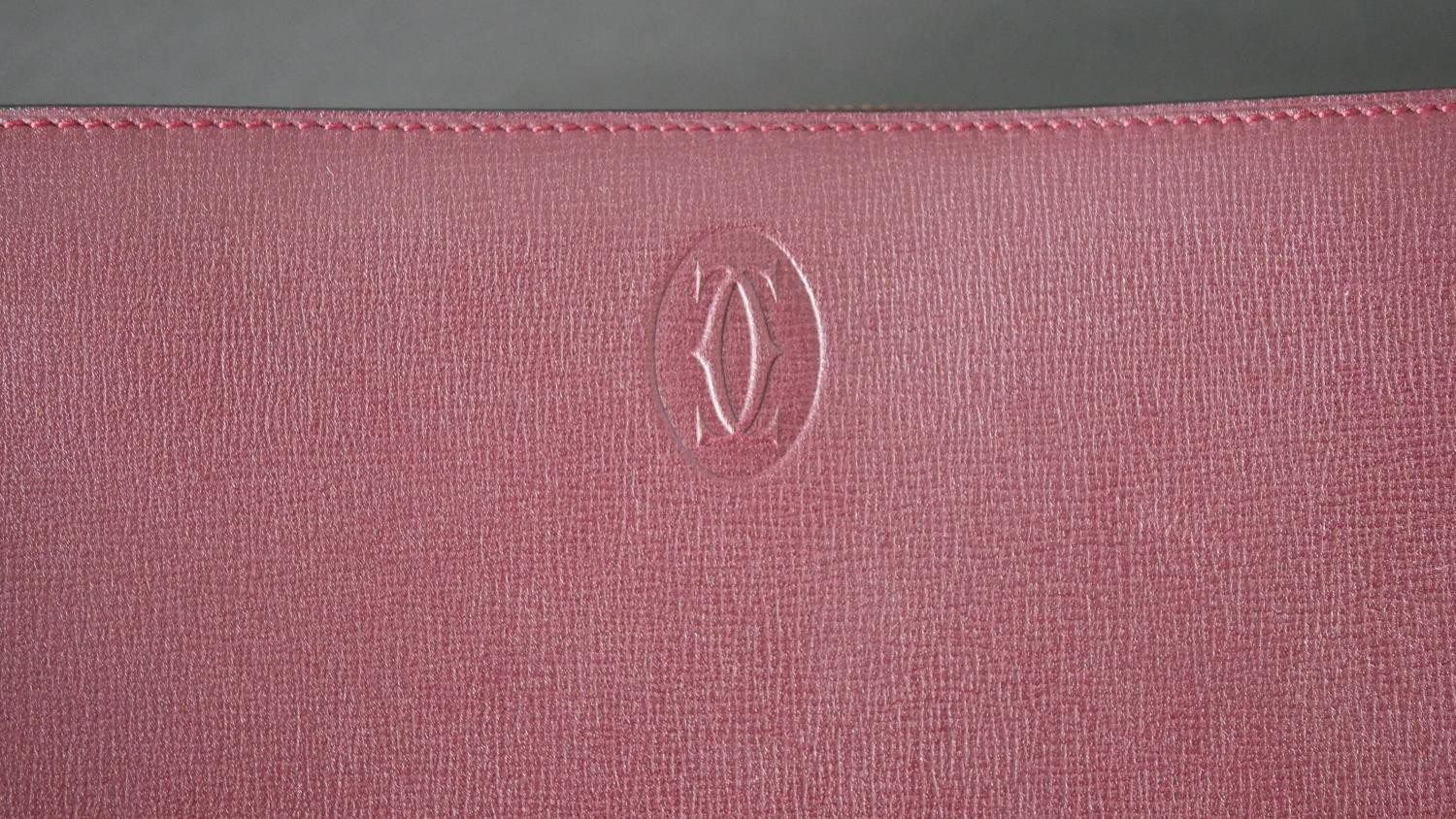 A leather Cartier clutch bag with red silk interior with Cartier writing and raised Cartier monogram - Image 2 of 9