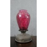 A Victorian brass and cranberry glass oil lamp. H.48 W.30cm