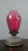 A Victorian brass and cranberry glass oil lamp. H.48 W.30cm