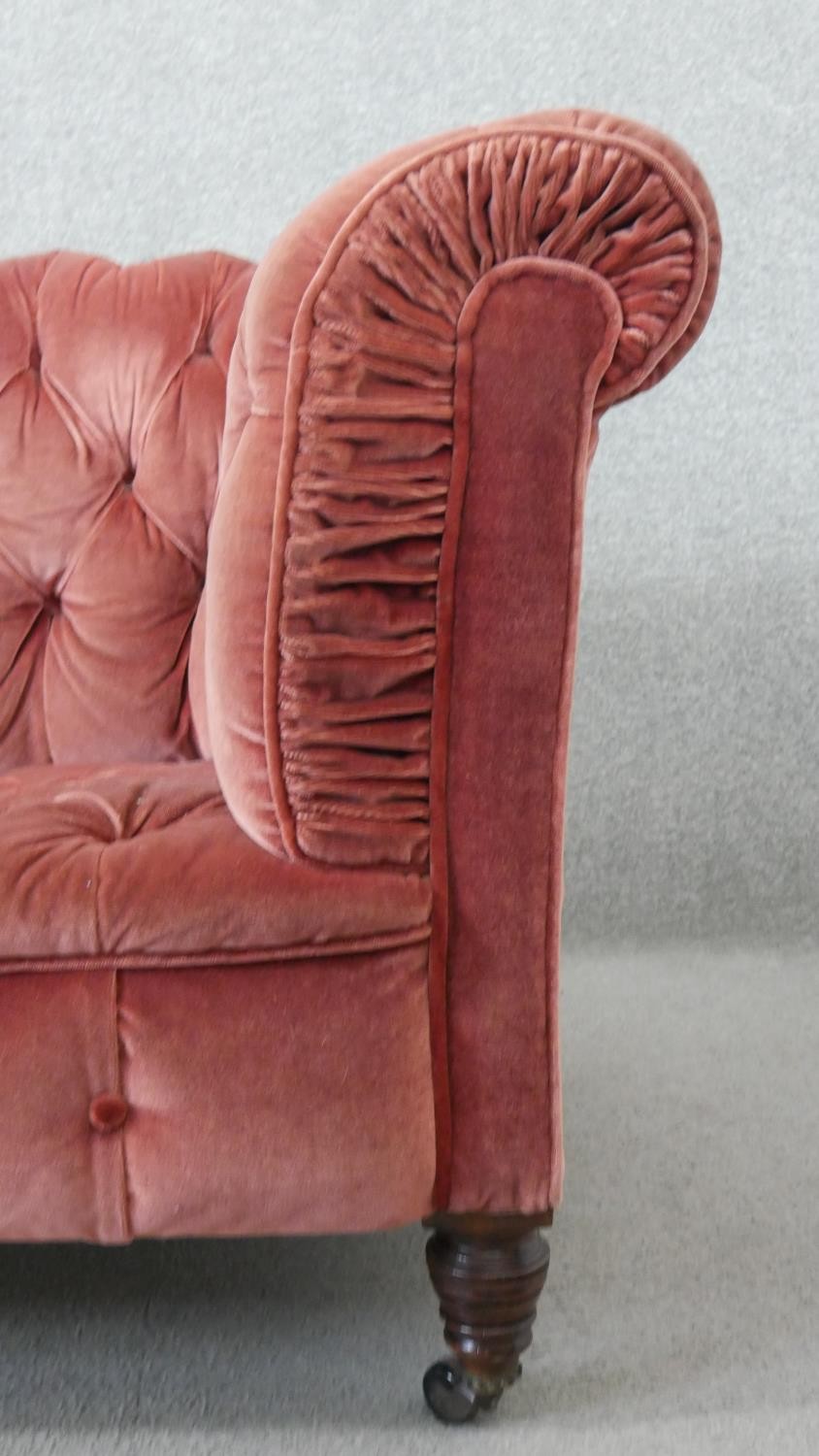 A Victorian Chesterfield sofa, upholstered in pink velour, buttoned to the back, arms, seat and - Image 4 of 6