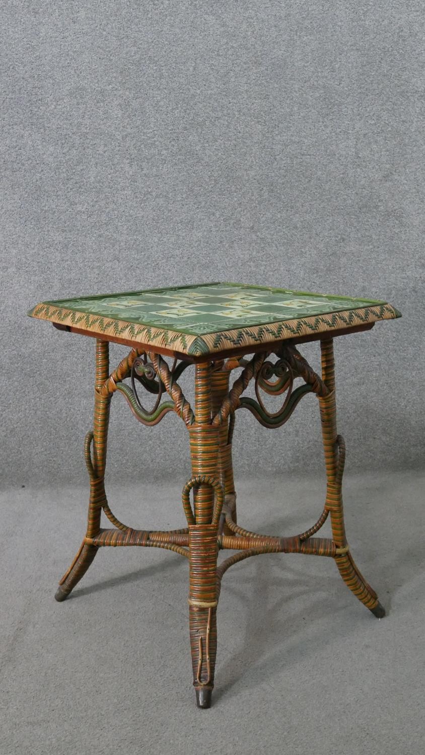 A wicker occasional table, the square top with green foliate Art Nouveau tiles, the splayed legs - Image 7 of 7
