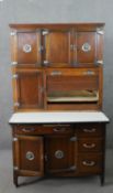 An early 20th century oak larder or pantry unit, with an arrangement of cupboard doors and