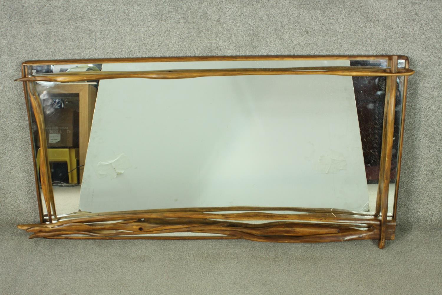 A contemporary designer driftwood wall mirror, signed and dated to the back. H.67 W.123cm.