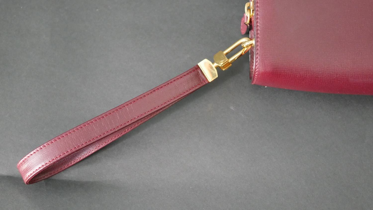 A leather Cartier clutch bag with red silk interior with Cartier writing and raised Cartier monogram - Image 3 of 9