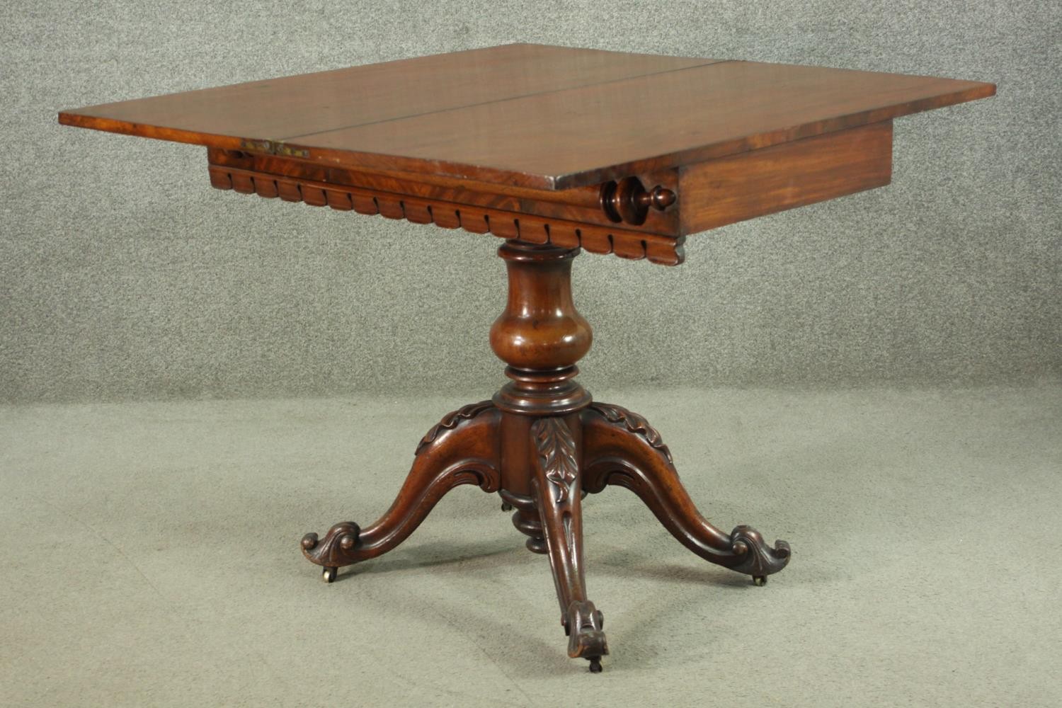 A Victorian figured walnut tea table, with a foldover top, over a baluster stem, on a quatraform - Image 6 of 7