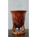 An Art Nouveau treacle glaze majolica planter with relief floral and foliate design. Impressed