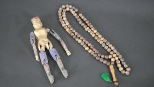 A 19th century Chinese painted and gilded temple fertility doll (arm loose but present) along with a