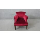 A late Victorian tub armchair, upholstered in pink velour, on turned walnut legs.