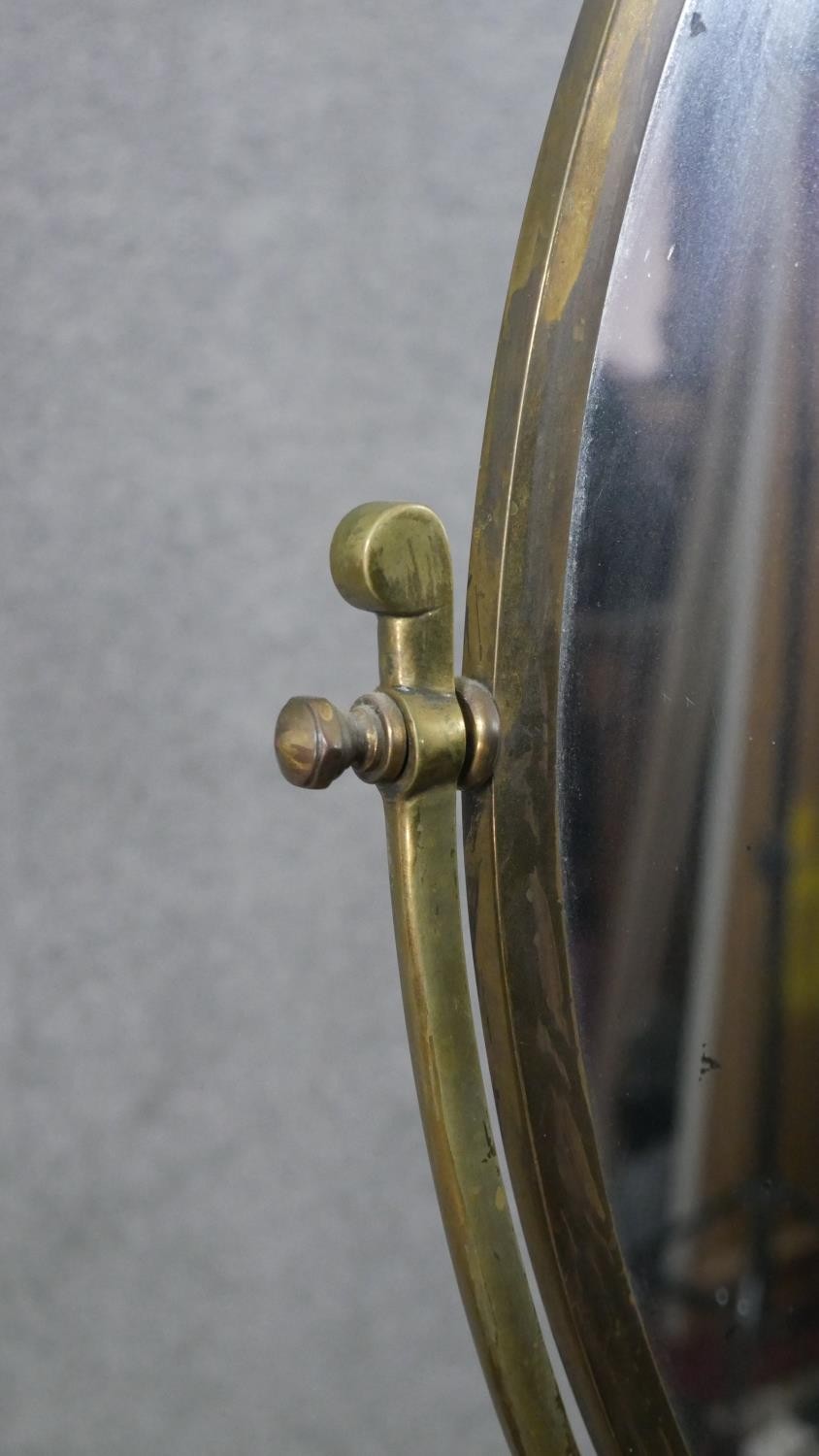 A large 20th century brass swing frame toilet mirror, with an oval mirror plate, on a circular base. - Image 5 of 6