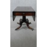 A Regency style mahogany drop leaf dining table, the end drawer with a turned handle, over a