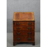 An 18th century style figured walnut bureau, of narrow proportions, with a crossbanded fall front