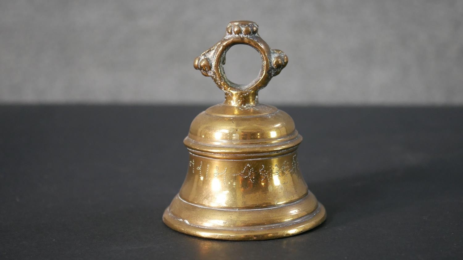 A collection of brass, including a pair of brass candlesticks with faceted design, a brass hand bell - Image 6 of 6