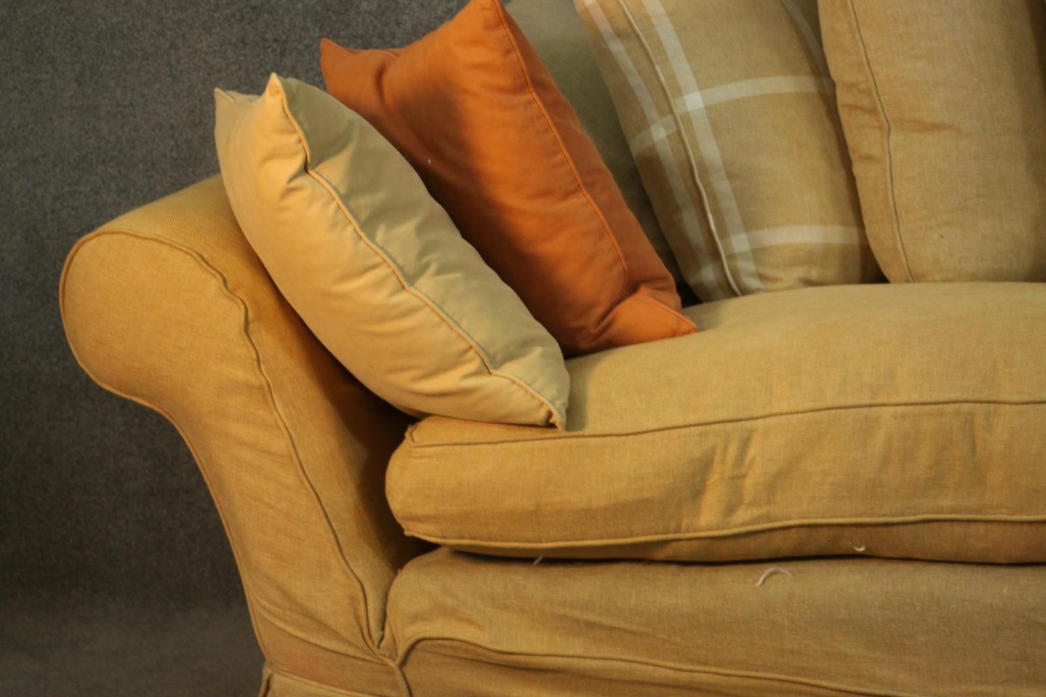 A contemporary three seater sofa, upholstered in ochre fabric, with scrolling arms and a selection - Image 4 of 8