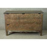 An 18th century oak mule chest, with a plank top over a fielded panel front, above three short