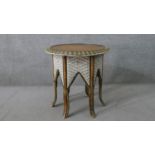 A Middle Eastern hexagonal occasional table, with a circular hardwood top, the sides with arched