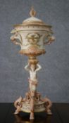 An early 19th century hand painted porcelain lidded urn, the top painted with gilded birds, mystical