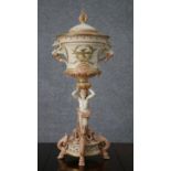 An early 19th century hand painted porcelain lidded urn, the top painted with gilded birds, mystical