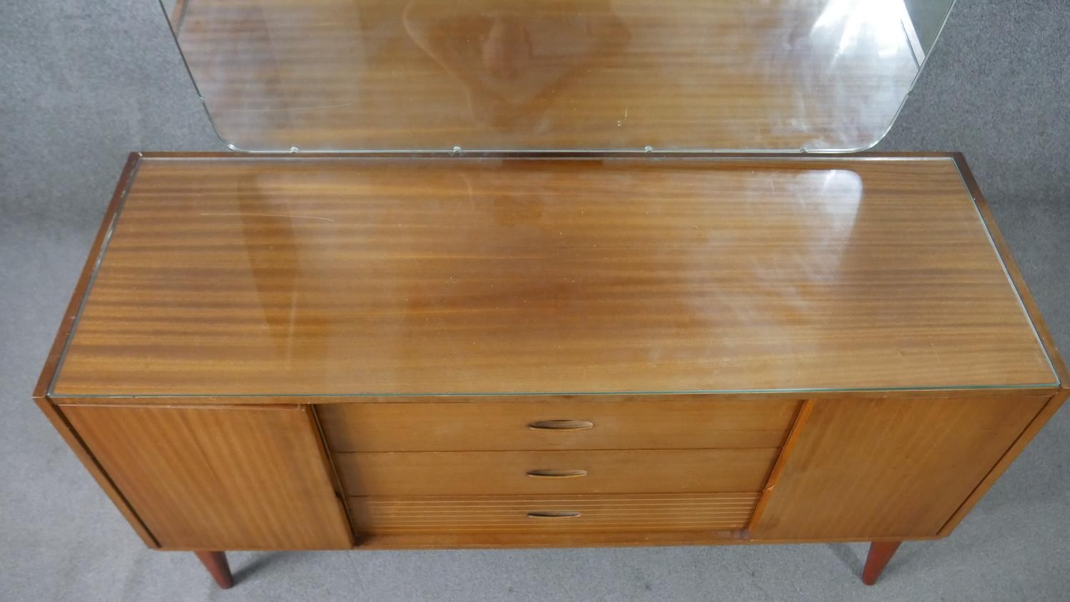 A circa 1960s teak dressing table, with a frameless mirror over three short drawers flanked by - Image 7 of 8