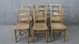 A set of six 19th century rustic pine kitchen chairs, with ladder back, over an elm seat, the legs