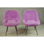 A pair of circa 1950s chairs, upholstered in shaggy purple fabric, on splayed powder coated metal