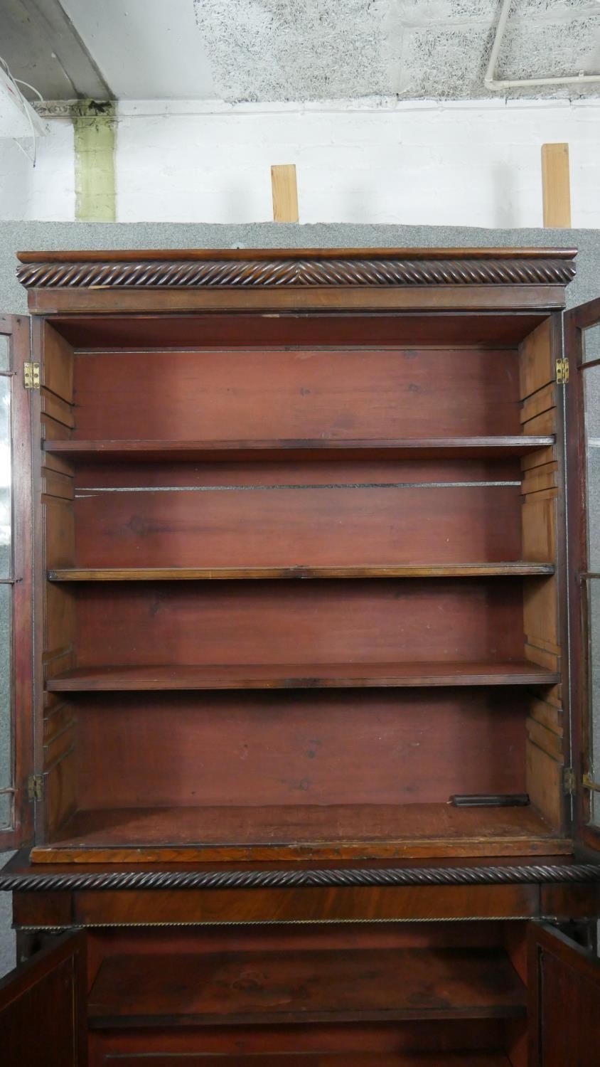 An early 19th century mahogany bookcase, with a gadrooned cornice over two glazed cupboard doors - Image 4 of 9