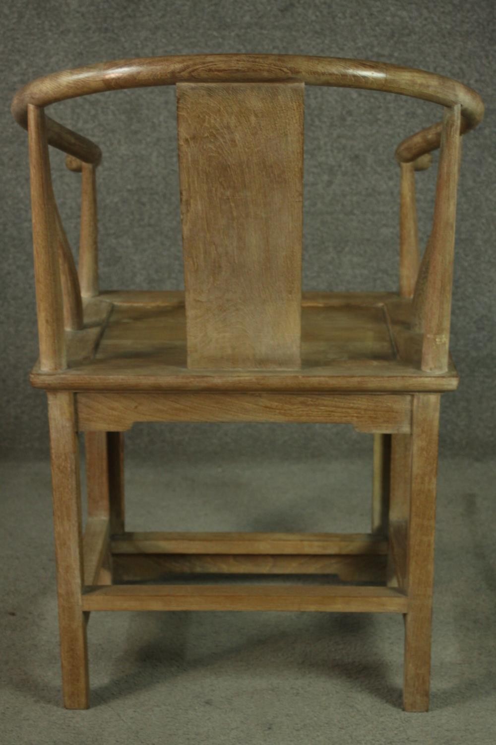 A pair of Chinese teak horseshoe back armchairs, with a plain splat back, the legs joined by - Image 6 of 17
