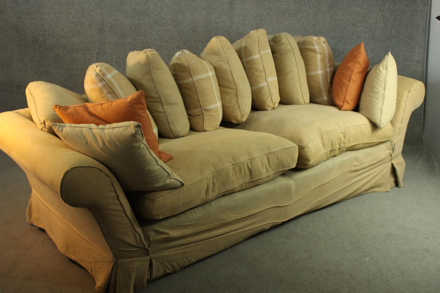 A contemporary three seater sofa, upholstered in ochre fabric, with scrolling arms and a selection - Image 6 of 8