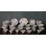 A twelve part early 20th century hand painted tea set, decorated with prunus blossom and a