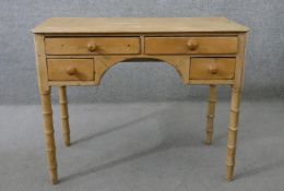 A Victorian pine kneehole desk, with an arrangement of four drawers with knob handles, on