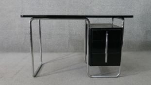 A Marcel Breuer style tubular chromed desk, with an ebonised rectangular top over an ebonised