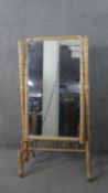 A late 19th century French carved beech faux bamboo cheval mirror, with a rectangular mirror
