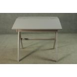A mid 20th century grey painted school desk, with a foldover top. H.71 W.75 D.56cm.