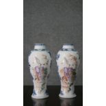 A pair of Qianlong 18th century Chinese hand painted vases with figural design and blue and white