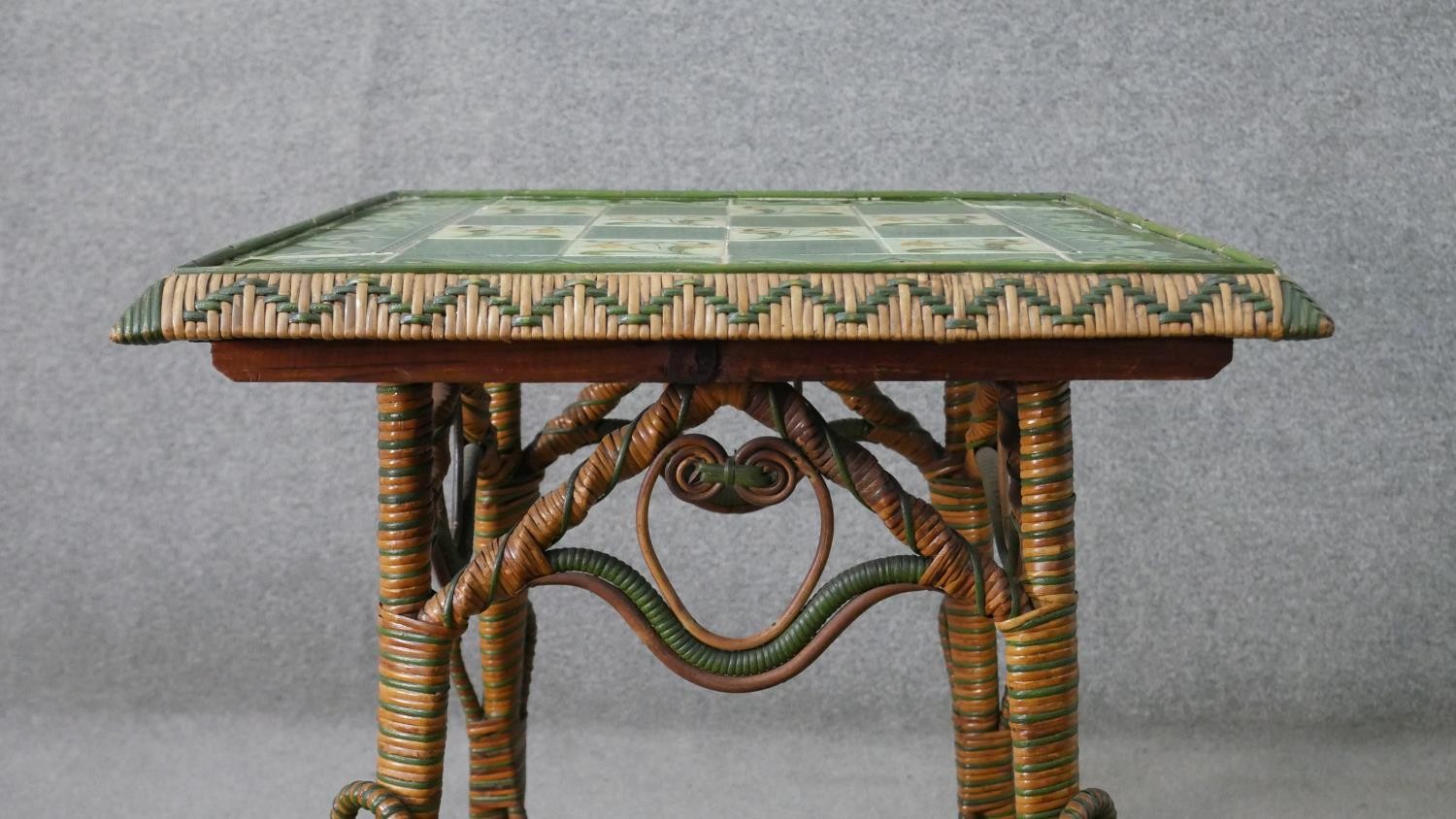 A wicker occasional table, the square top with green foliate Art Nouveau tiles, the splayed legs - Image 2 of 7