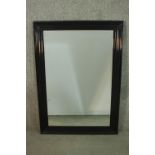 A contemporary ebonised mirror, with a rectangular mirrored plate in a moulded frame. H.107 W.76cm
