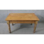 A Victorian pine kitchen table, the rectangular plank top over an end drawer with a knob handle,