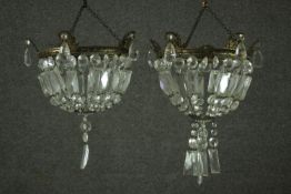 A pair of small basket form chandeliers, with brass mounts, hung with lustres. H.45 Dia. 23cm.
