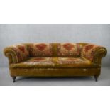 A late Victorian Chesterfield sofa, upholstered in green velvet, with sections of Persian Sarouk