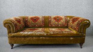 A late Victorian Chesterfield sofa, upholstered in green velvet, with sections of Persian Sarouk