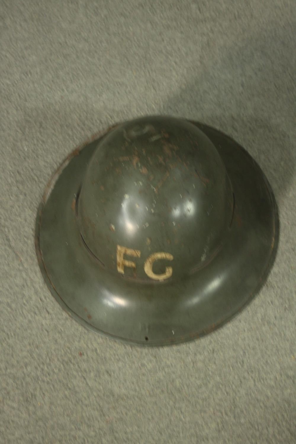 A WWII childs respirator with military issue gas mask and WWII helmet, stamped FG. H47 W.40cm. ( - Image 7 of 9