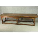 An 18th century oak refectory table, the plank top with cleated ends, on six turned and block